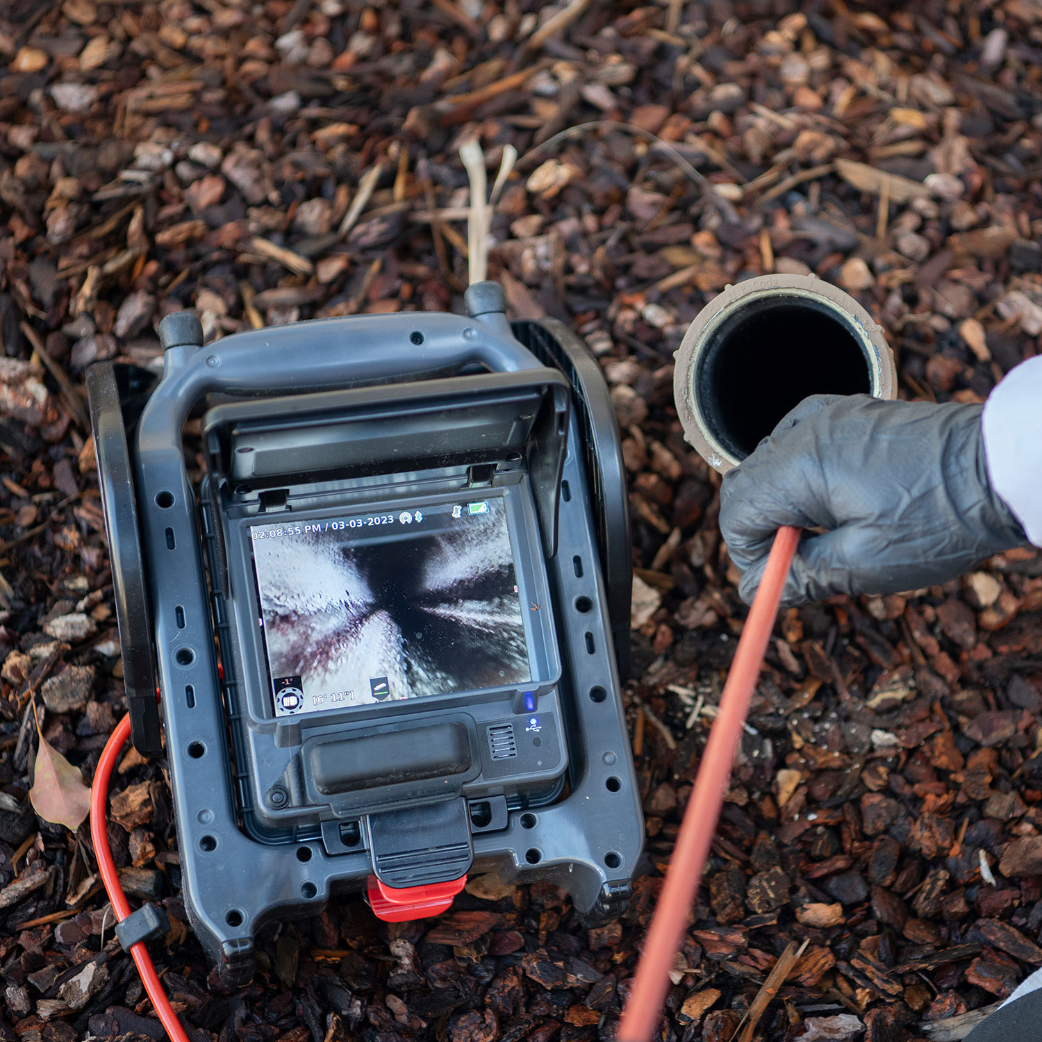 Camera being placed down pipe